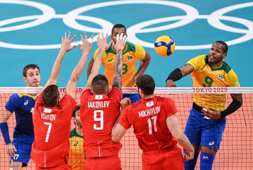 Brazil's Yoandy Leal Hidalgo (R) spikes the ball in the men's semi-final volleyball match between Brazil and Russia during the Tokyo 2020 Olympic Games at Ariake Arena in Tokyo on August 5, 2021. (Photo by YURI CORTEZ / AFP)