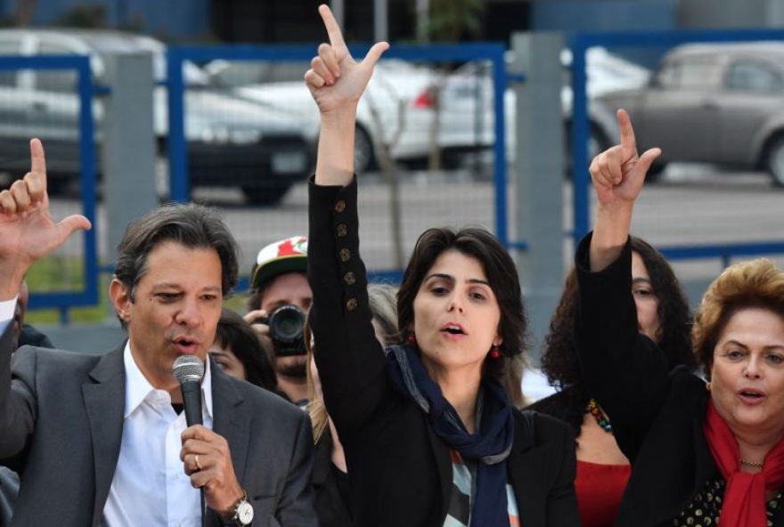 Brazil's presidential candidate for the Workers' Party (PT) Fernando Haddad (L) gestures next to vice presidential candidate Manuela D'Avila (C) and former president Dilma Rousseff after the official announcement of their candidacy outside the Federal Police Superintendence -where Lula da Silva is imprisoned- in Curitiba, in southern Brazil on September 11, 2018. - Haddad's ability to hold on to Lula's base will be key if he and his expected running mate, youthful communist Manuela d'Avila, are to reach the second round of Brazil's presidential election. (Photo by NELSON ALMEIDA / AFP)        (Photo credit should read NELSON ALMEIDA/AFP via Getty Images)