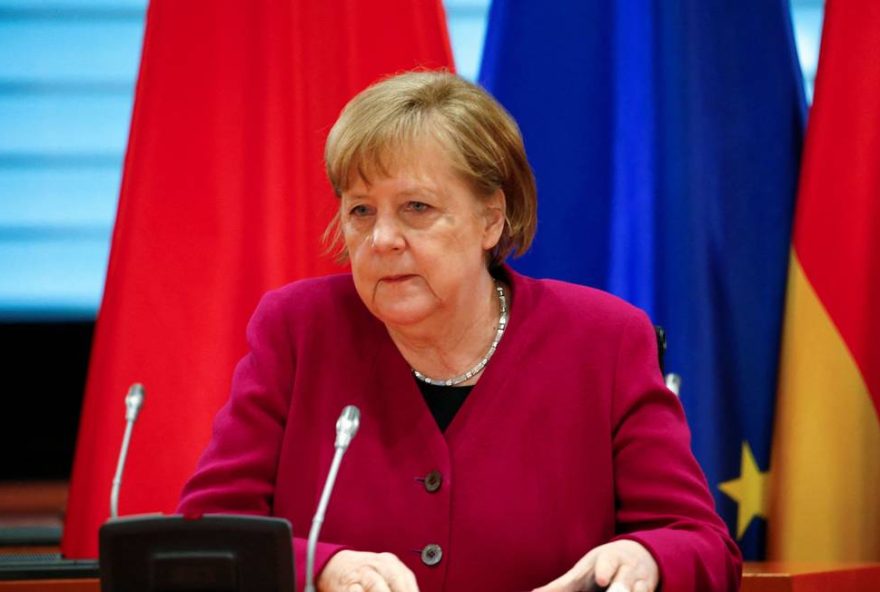 92652458_German-Chancellor-Angela-Merkel-attends-a-video-conferenced-meeting-with-Chinas-Premier-Li