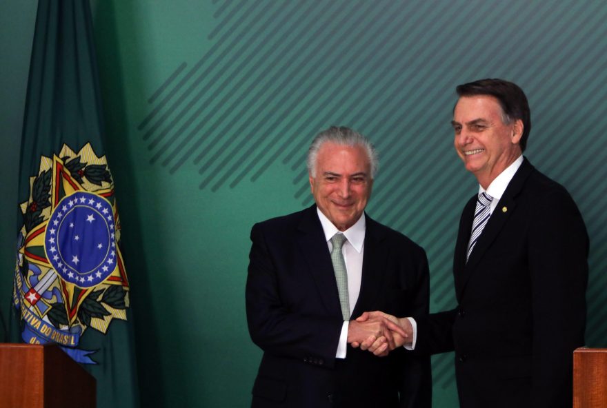 Michel Temer, Brazil's president, left, shakes hands with Jair Bolsonaro, Brazil's president-elect, during press conference in Brasilia, Brazil, on Wednesday, Nov. 7, 2018. Temer said he was willing to collaborate intensively with the transition, and asked the president-elect Bolsonaro to tell him which are the projects underway in Congress that he's interested in approving. 