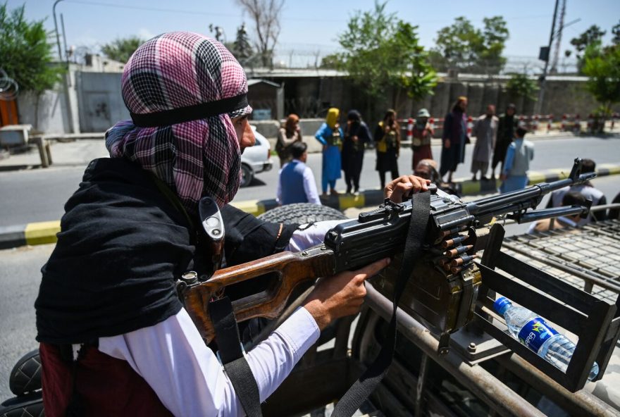 TOPSHOT - A Taliban fighter mans a machinegun on top of a vehicle as they patrol along a street in Kabul on August 16, 2021, after a stunningly swift end to Afghanistan's 20-year war, as thousands of people mobbed the city's airport trying to flee the group's feared hardline brand of Islamist rule. (Photo by Wakil Kohsar / AFP) (Photo by WAKIL KOHSAR/AFP via Getty Images)