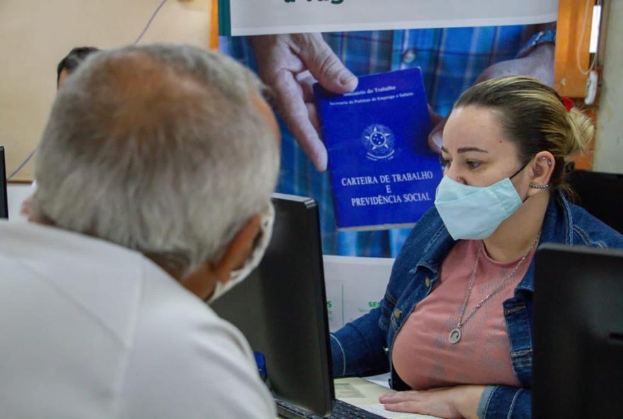 Na foto se vê pessoas em busca de vagas em feirão de empregos