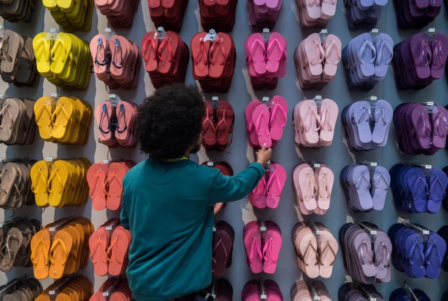 FILES-BRAZIL-POLITICS-HAVAIANAS (FILES) An employee touches a pair of Brazilian Havaianas flip-flops at a store in Sao Paulo, Brazil, on July 18, 2017. The famous flip-flop brand Havaianas is facing on December, 2025 a boycott call from Brazilian politicians following an advertisement considered contrary to right-wing views in the run-up to next year's presidential elections. (Photo by NELSON ALMEIDA / AFP)