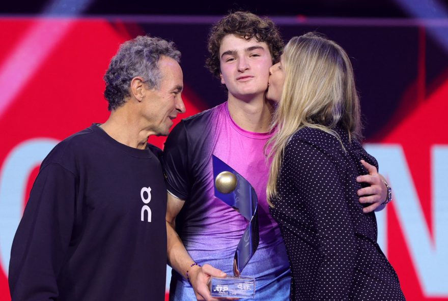 Tennis - Next Gen ATP Finals - King Abdullah Sports City, Jeddah, Saudi Arabia - December 22, 2024 Brazil's Joao Fonseca celebrates with his parents Roberta and Christiano Fonseca and the trophy after winning the final match against Learner Tien of the U.S. REUTERS/Stringer