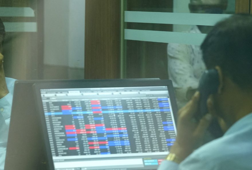 A broker speaks on his phone as he trades at his computer terminal inside a stock brokerage firm in Mumbai, India, August 1, 2025. REUTERS/Hemanshi Kamani