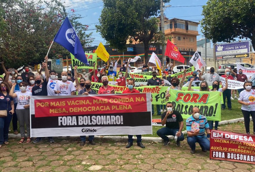 Manifestantes seguram faixas na manifestação que acontece na Praça do Trabalhador, em Goiânia