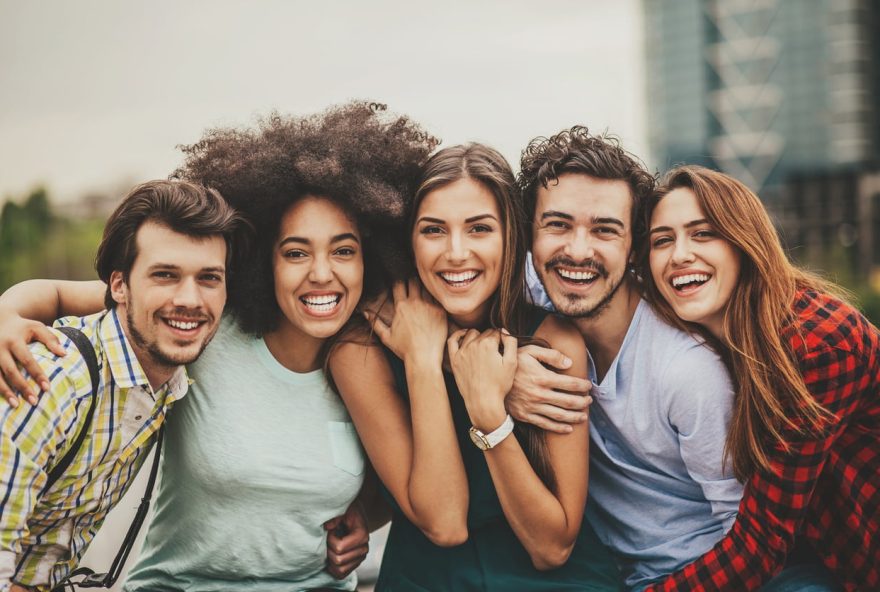 Group of mixed race people looking at the camera outdoors in the city