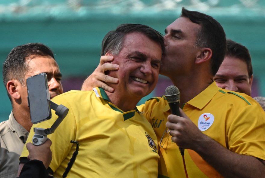 BRAZIL-POLITICS-ELECTION-JUSTICE-BOLSONARO Former Brazilian president Jair Bolsonaro (L) and Senator Flavio Bolsonaro (R) attend a political rally to support congressman Alexandre Ramagem as candidate to become Rio de Janeiro mayor in the upcoming municipal election, in Rio de Janeiro on July 18, 2024. Congressman Alexandre Ramagem, head of Brazil's intelligence services during Jair Bolsonaro's presidency, testified to police on July 17, 2024, as part of an investigation into alleged illegal spying on senior political figures and other personalities. (Photo by MAURO PIMENTEL / AFP)