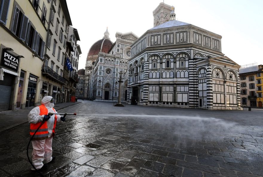 (FILES) In this file photo taken on March 21, 2020, an employee of the municipal company disinfects Piazza del Duomo, in Florence, as part of the measures taken by Italian government to fight against the spread of the COVID-19, the novel coronavirus. - Close to one billion people worldwide were confined to their homes on March 21, 2020, as the global coronavirus death toll shot past 11,000 and US states rolled out lockdown measures already imposed across swathes of Europe. The pandemic has completely upended lives across the planet, restricting movement, shutting schools and forcing millions to work from home. (Photo by Carlo BRESSAN / AFP)