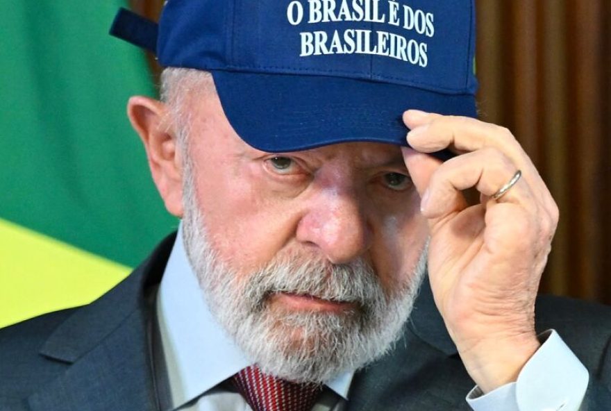 (FILES) Brazil's President Luiz Inacio Lula da Silva puts on a cap reading 