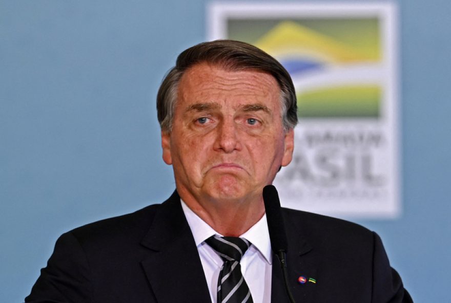 (FILES) In this file photo taken on August 26, 2021 Brazilian President Jair Bolsonaro gestures as he delivers a speech during the celebration of National Volunteer Day at Planalto Palace in Brasilia. - Bolsonaro said on August 30, 2021, that the U.S. government, which he defined as 'more left-wing' has 'almost an obsession' with the environment that 