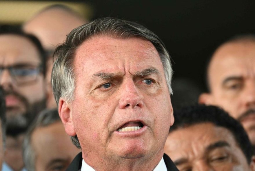 (FILES) Former Brazil's President Jair Bolsonaro speaks to the media after leaving the Senate building in Brasilia on March 26, 2025. A Brazilian judge on Tuesday declared far right ex-president Jair Bolsonaro, who is under house arrest while awaiting the verdict in his coup-plotting trial, a 