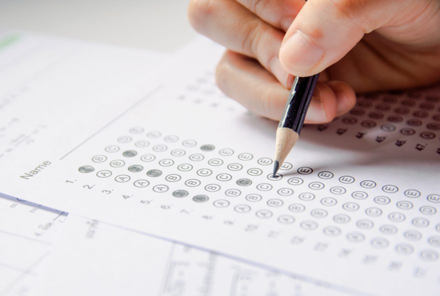 Students,Hand,Holding,Pencil,Writing,Selected,Choice,On,Answer,Sheets