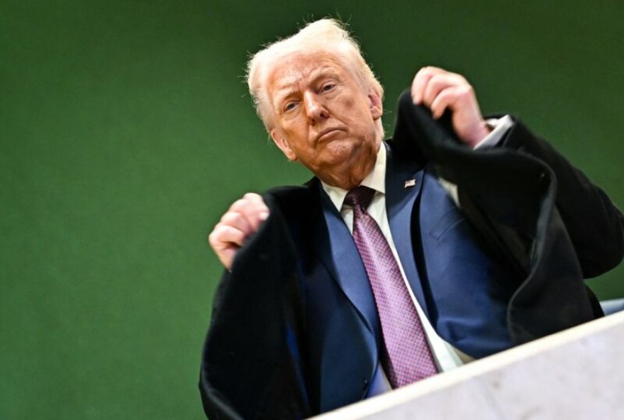 SWITZERLAND-US-POLITICS-ECONOMY-DIPLOMACY US President Donald Trump adjusts his jacket as he leaves the Congress Centre during the World Economic Forum (WEF) annual meeting in Davos on January 22, 2026. US President Donald Trump will show off his new