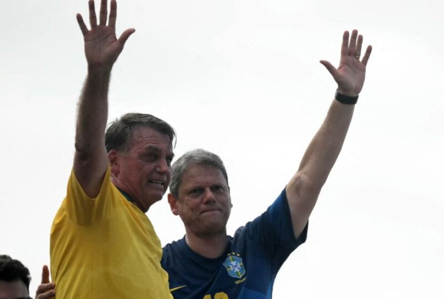 BRAZIL-POLITICS-BOLSONARO-DEMO Brazil's former president Jair Bolsonaro (L) waves next to Sao Paulo Governor Tarcisio de Freitas during a rally in Rio de Janeiro, Brazil, on March 16, 2025. Facing a possible trial for attempted coup d'état, former Brazilian president Jair Bolsonaro called on his supporters to demonstrate this Sunday in Rio de Janeiro to show that he remains leader of the opposition ahead of the 2026 elections. (Photo by Mauro PIMENTEL / AFP)