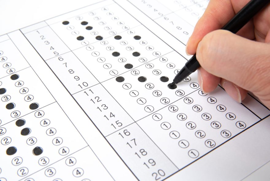 Man,Is,Filling,Omr,Sheet,Handing,With,Pen.